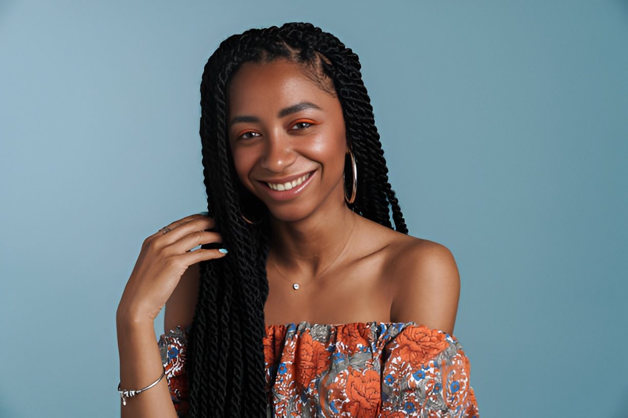 Client with beautifully styled long braids, smiling